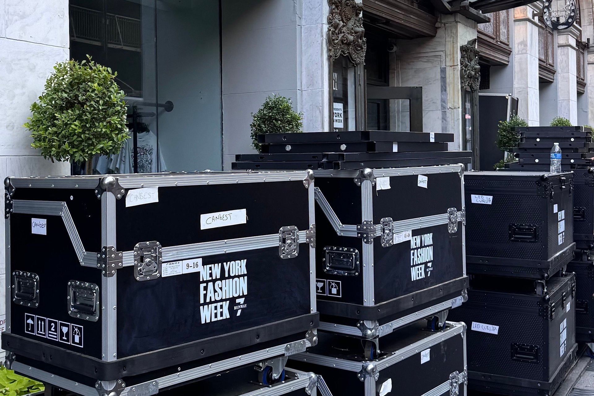 Stacked equipment flight cases outside a venue