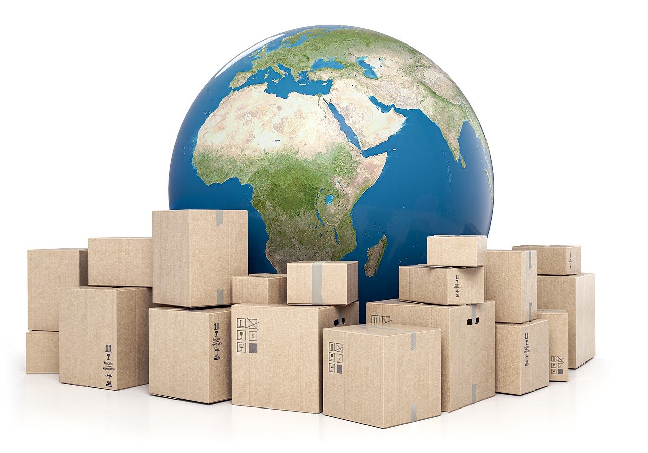 A globe standing behind a pile of cardboard boxes