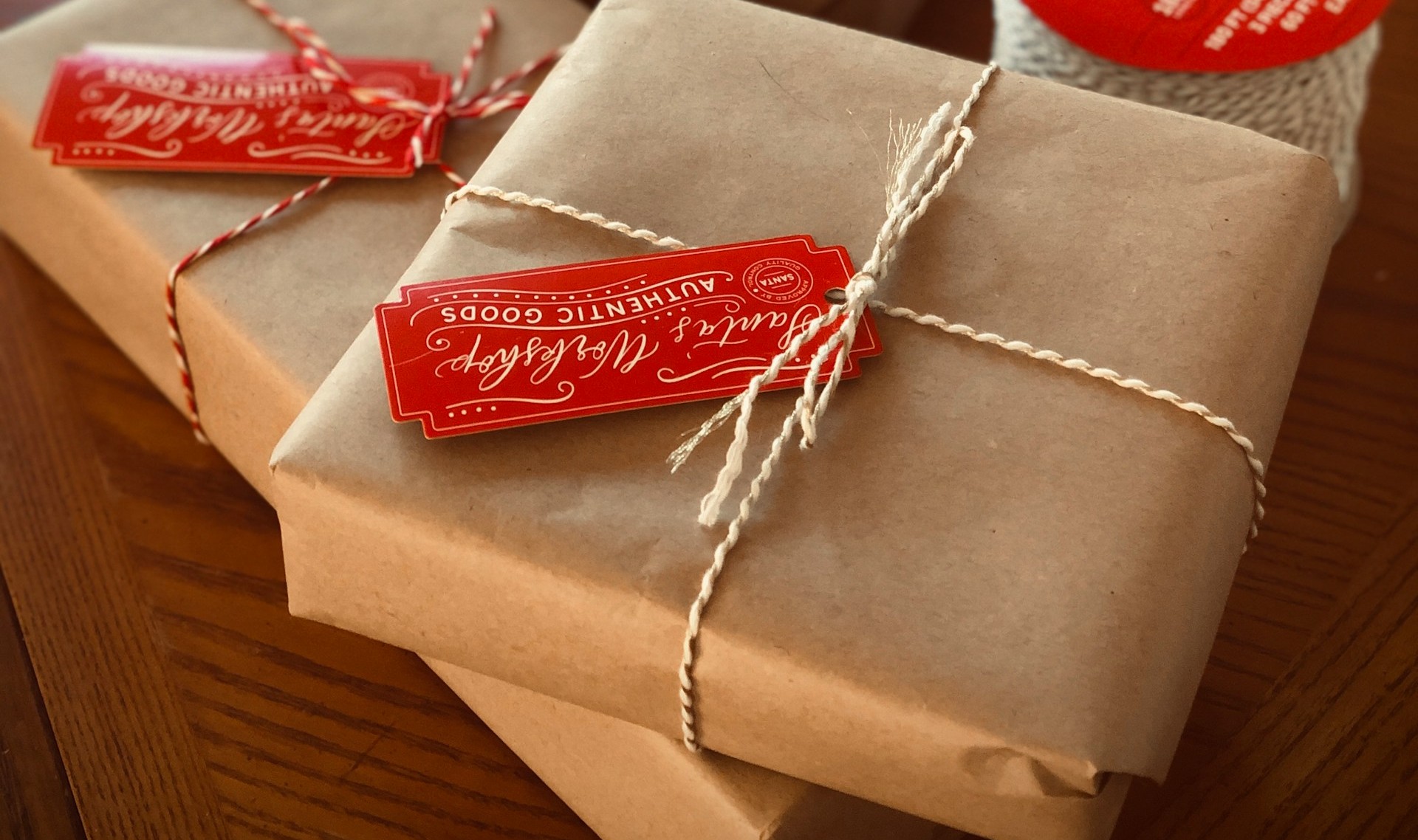 Parcels wrapped in brown paper and tied with string, with red gift tags