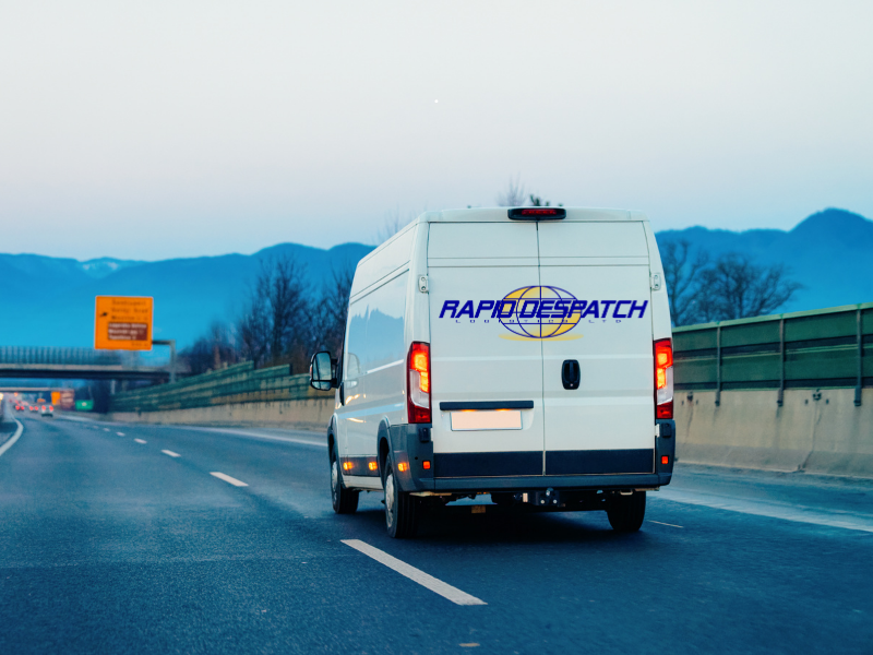 A white Rapid Despatch van on a motorway with mountains in the distance