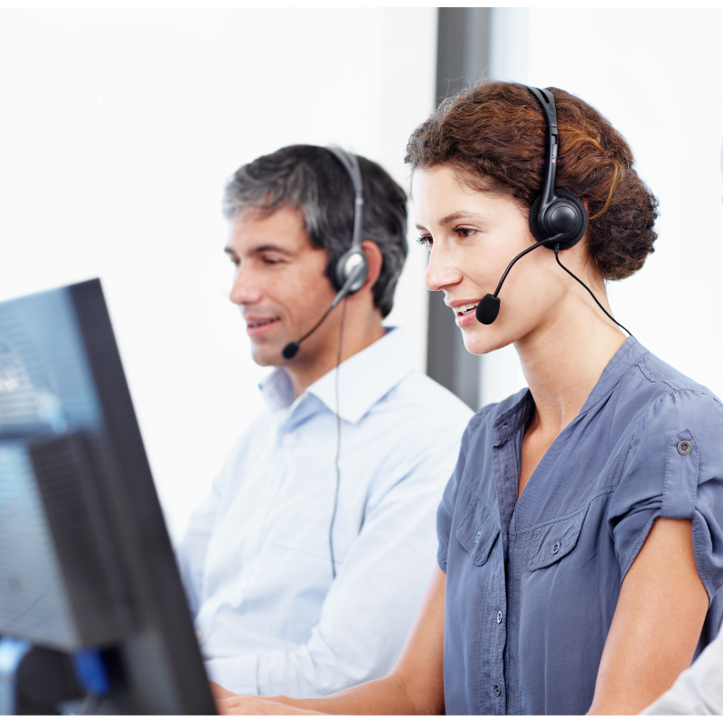 Two controllers wearing headsets working at computer screens