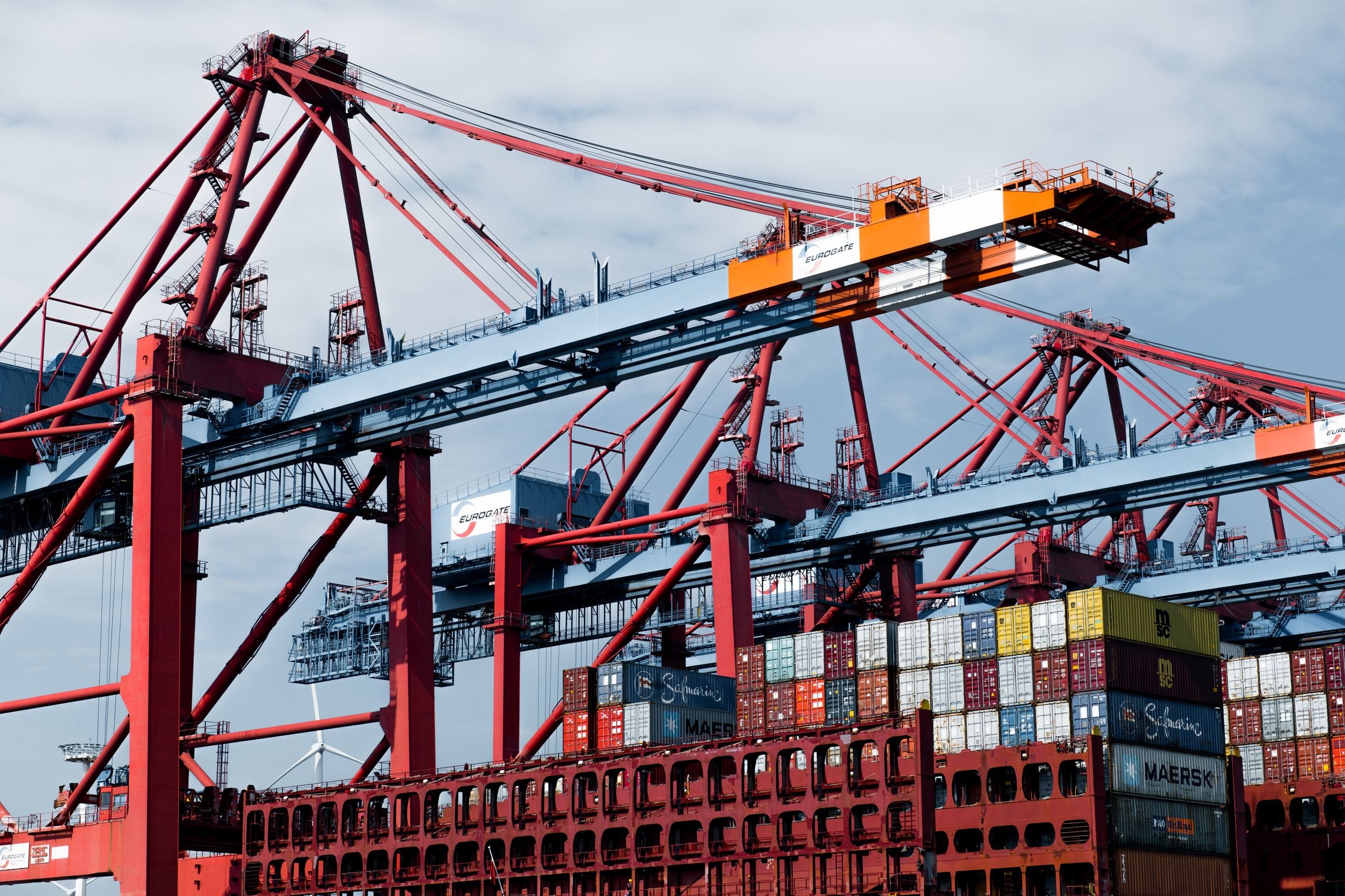 Cranes and stacked shipping containers at a port