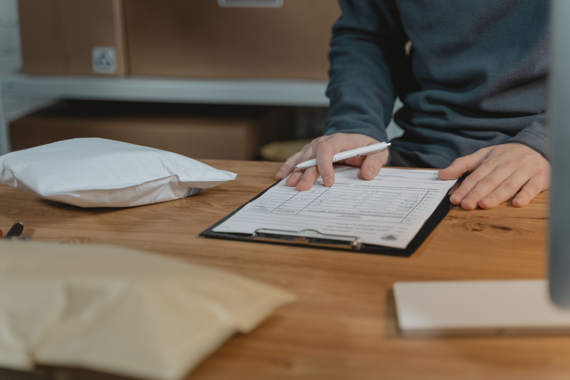 A person filling in a form on a clipboard