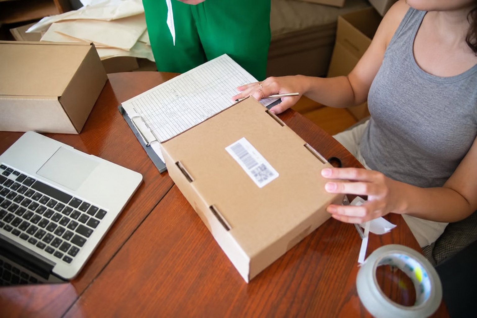 Someone packing and labelling an online order at a desk